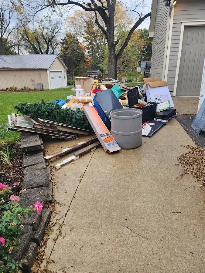 Dumpster being loaded with debris for 12 Yard Dumpster Rental in LaGrange